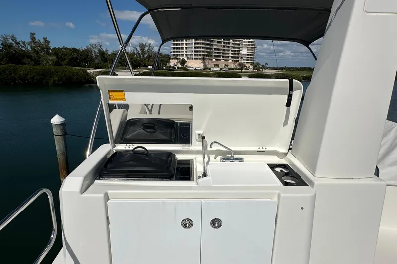 Mer Sea Yacht Photos Pics Outdoor kitchen on 2021 Beneteau Swift Trawler 41 Fly, featuring grill and sink.