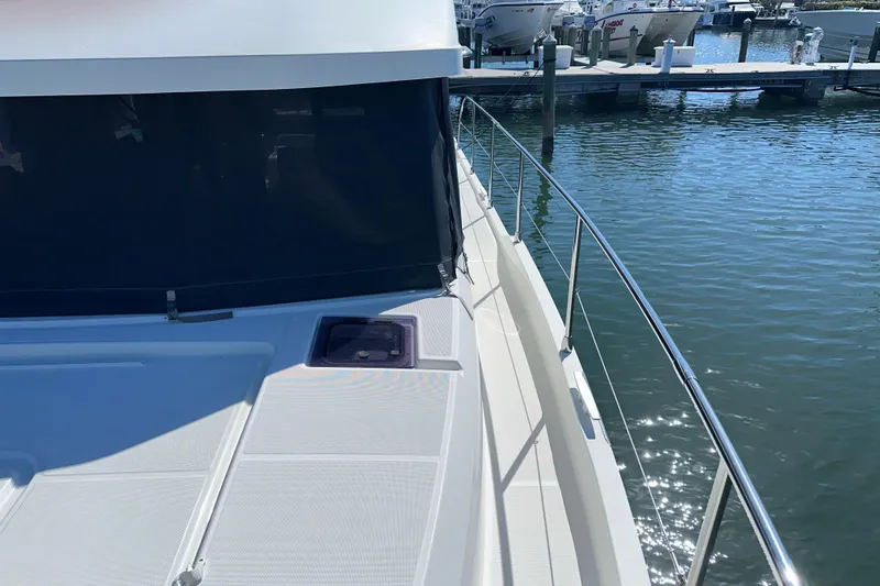 Mer Sea Yacht Photos Pics 2021 Beneteau Swift Trawler 41 Fly docked, showcasing sleek deck and railing design.