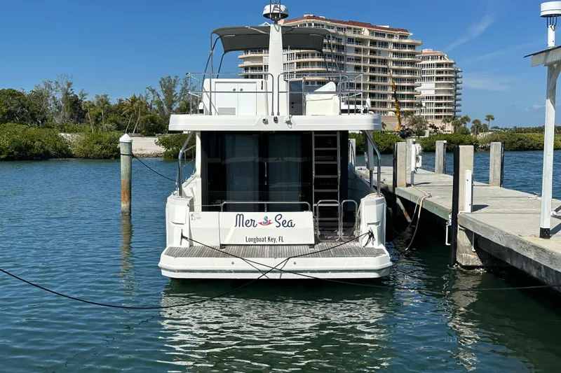Mer Sea Yacht Photos Pics 2021 Beneteau Swift Trawler 41 Fly docked at Longboat Key, Florida marina.