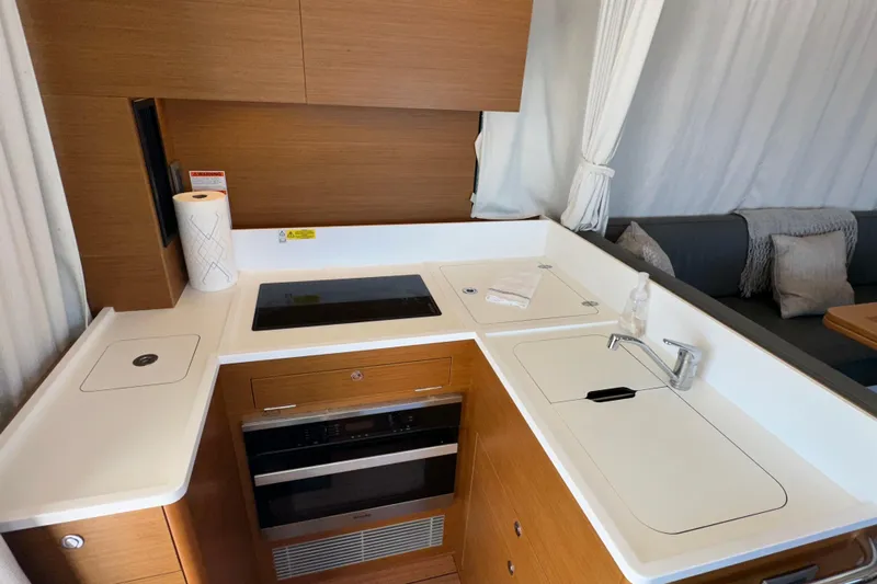 Mer Sea Yacht Photos Pics Modern kitchen in 2021 Beneteau Swift Trawler 41 Fly yacht, featuring sleek appliances and wood finish.