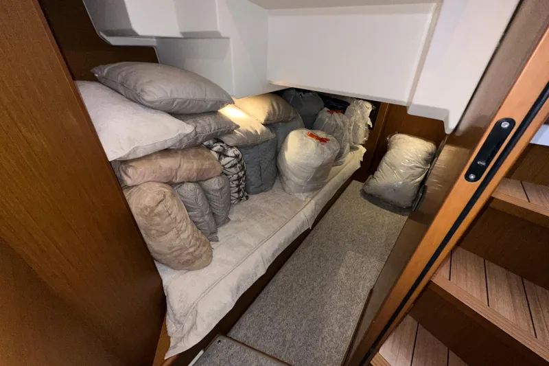 Mer Sea Yacht Photos Pics Interior storage area of 2021 Beneteau Swift Trawler 41 Fly with cushions and bags.