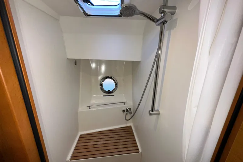 Mer Sea Yacht Photos Pics Shower area in 2021 Beneteau Swift Trawler 41 Fly with wooden floor and porthole.