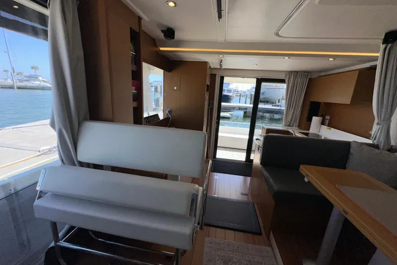 Mer Sea Yacht Photos Pics Interior of 2021 Beneteau Swift Trawler 41 Fly, featuring modern seating and dockside view.