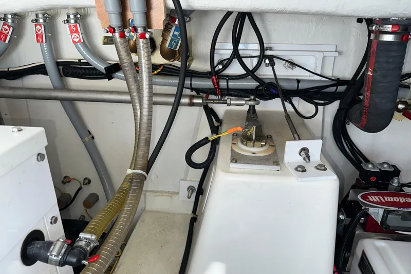 Mer Sea Yacht Photos Pics Engine room of 2021 Beneteau Swift Trawler 41 Fly with visible hoses and wiring.