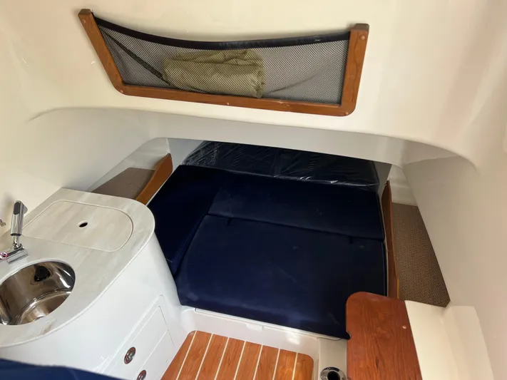  Yacht Photos Pics 2025 Grady-White Canyon 336 cabin interior with sink and blue seating.