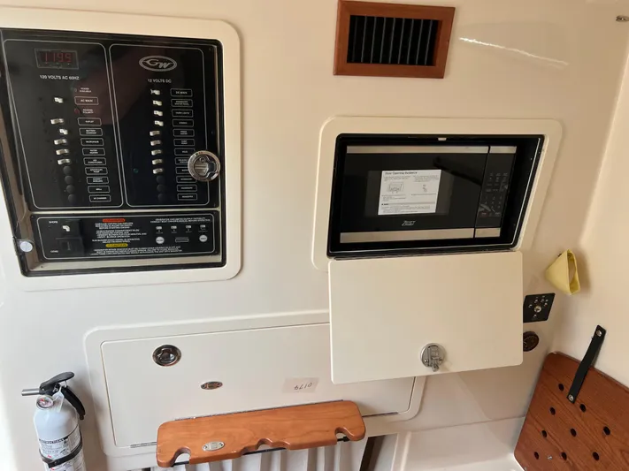  Yacht Photos Pics Control panel and microwave inside 2025 Grady-White Canyon 336 boat cabin.