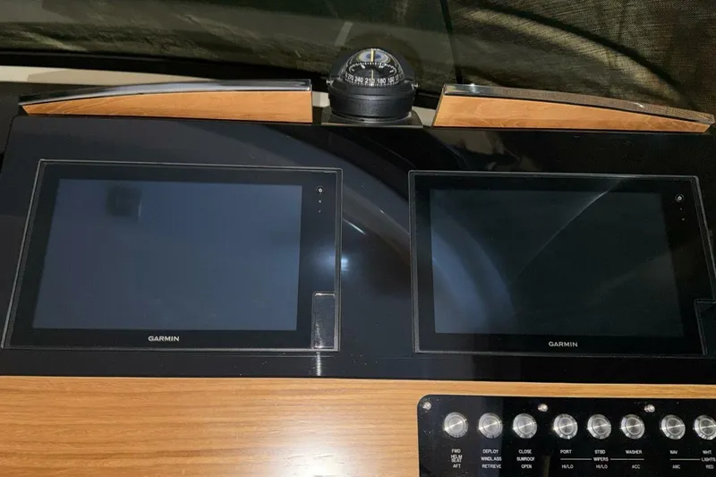 Strange Magic II Yacht Photos Pics Dashboard of 2018 Tiara Yachts C44 Coupe with Garmin displays and compass.