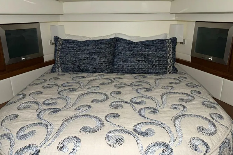 Strange Magic II Yacht Photos Pics Luxurious cabin interior of 2018 Tiara Yachts C44 Coupe with elegant bedding.