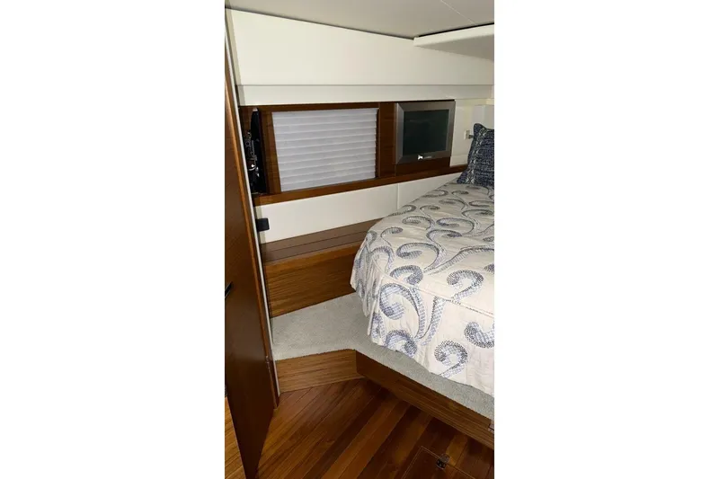 Strange Magic II Yacht Photos Pics 2018 Tiara Yachts C44 Coupe bedroom with elegant bedding and wood accents.