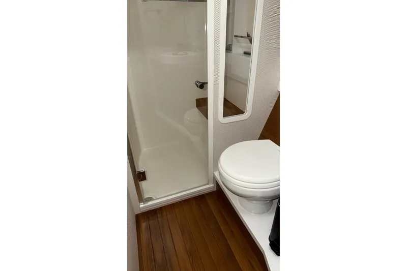 Strange Magic II Yacht Photos Pics 2018 Tiara Yachts C44 Coupe bathroom with wooden flooring and modern fixtures.