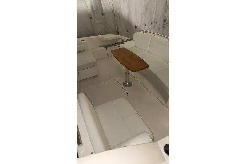 Strange Magic II Yacht Photos Pics Interior of 2018 Tiara Yachts C44 Coupe with seating and wooden table.