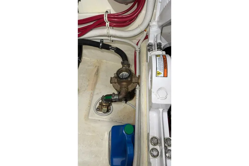 Strange Magic II Yacht Photos Pics Engine compartment of 2018 Tiara Yachts C44 Coupe with visible hoses and components.