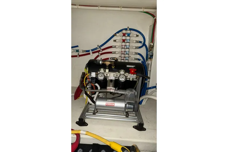 Strange Magic II Yacht Photos Pics Engine room of 2018 Tiara Yachts C44 Coupe with visible machinery and wiring.