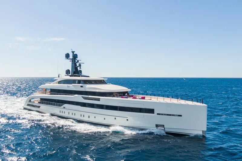 Rio Yacht Photos Pics Luxurious 2022 CRN 62m yacht cruising on open sea under clear blue sky.