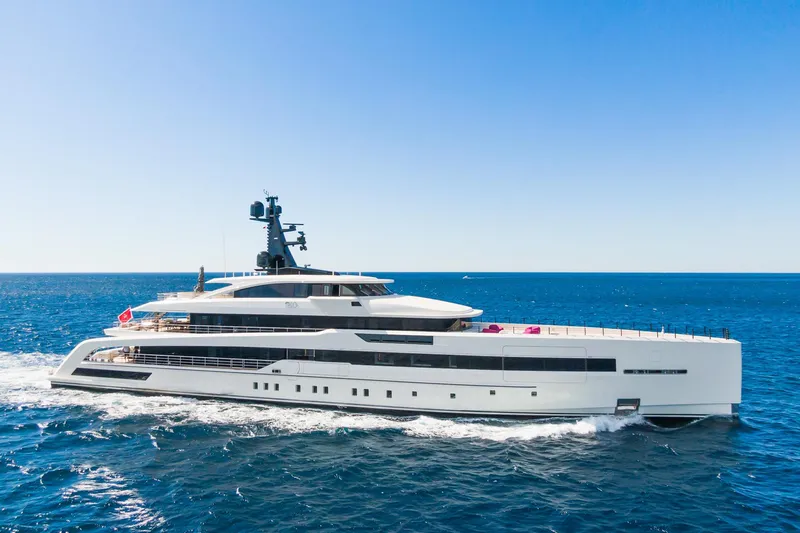 Rio Yacht Photos Pics Luxurious 2022 CRN 62m yacht cruising on open sea under clear blue sky.