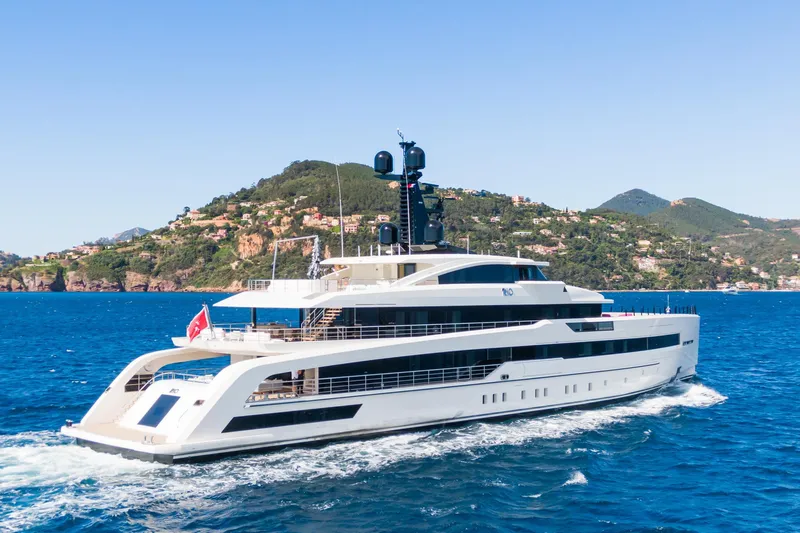 Rio Yacht Photos Pics Luxurious 2022 CRN 62m yacht cruising near scenic coastal landscape.