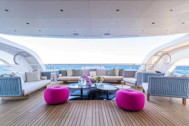 Rio Yacht Photos Pics Luxurious CRN 62m yacht deck with modern seating, vibrant pink ottomans, and ocean view, 2022 model.