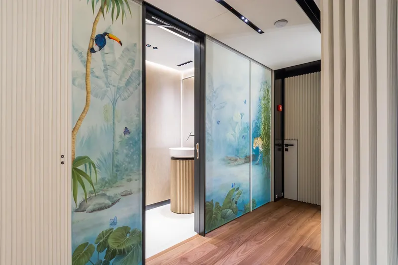 Rio Yacht Photos Pics Luxurious CRN 62m yacht interior with tropical-themed sliding doors, featuring vibrant toucan and jungle artwork.
