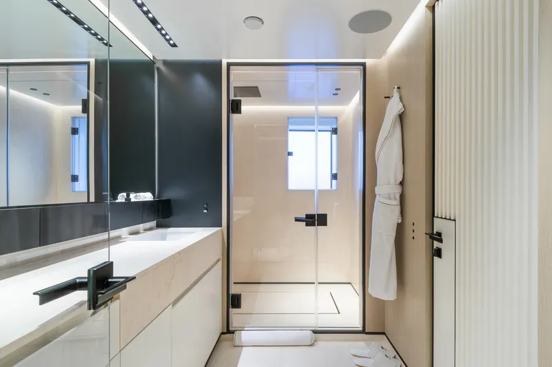 Rio Yacht Photos Pics Luxurious modern bathroom on CRN 62m yacht, 2022 model, featuring sleek design and glass shower.
