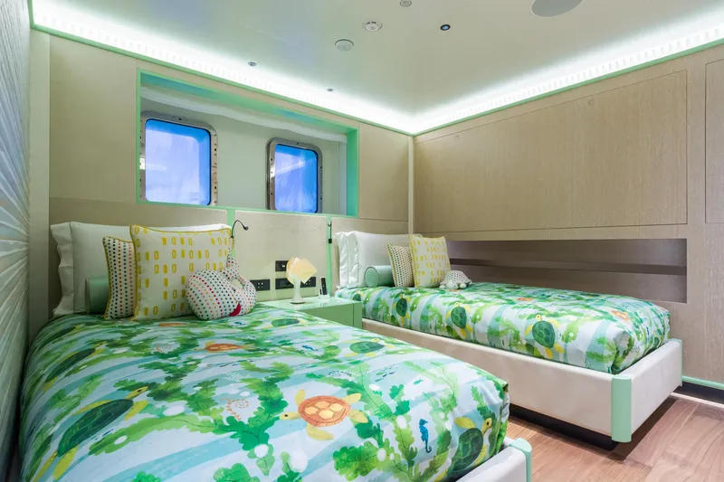Rio Yacht Photos Pics Luxurious CRN 62m yacht bedroom, 2022 model, featuring twin beds with vibrant, nature-themed bedding.