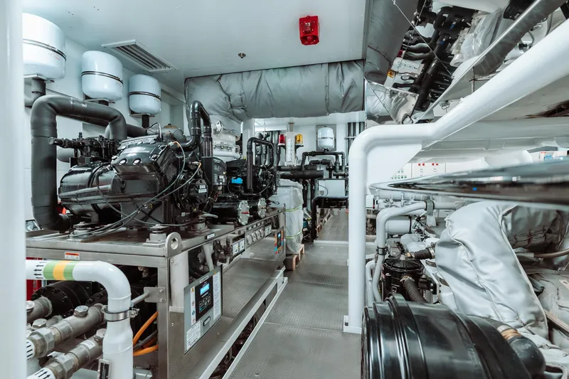 Rio Yacht Photos Pics Engine room of a 2022 CRN 62m yacht, showcasing advanced machinery and piping systems.