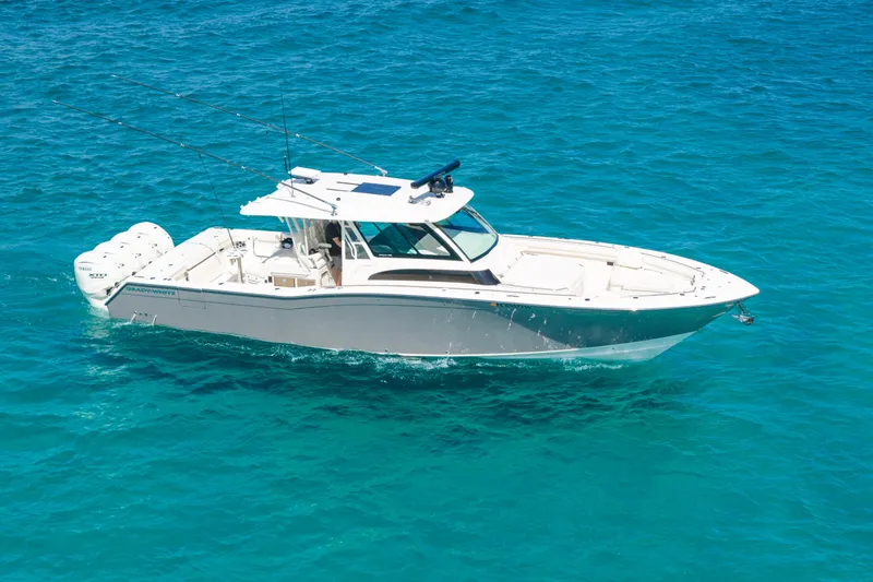  Yacht Photos Pics 2025 Grady-White Canyon 456 boat cruising on clear blue water.