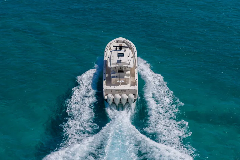  Yacht Photos Pics 2025 Grady-White Canyon 456 cruising on clear blue ocean waters.