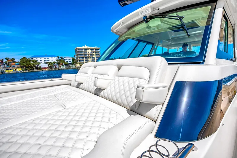  Yacht Photos Pics 2025 Grady-White Canyon 456 boat with luxurious seating, cruising on a sunny day.