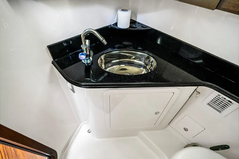  Yacht Photos Pics Luxury bathroom sink in 2025 Grady-White Canyon 456 boat, featuring sleek design and modern fixtures.