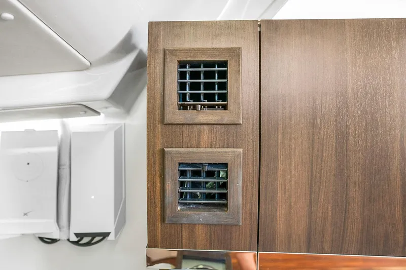  Yacht Photos Pics Interior of 2025 Grady-White Canyon 456 with wooden cabinetry and ventilation grilles.