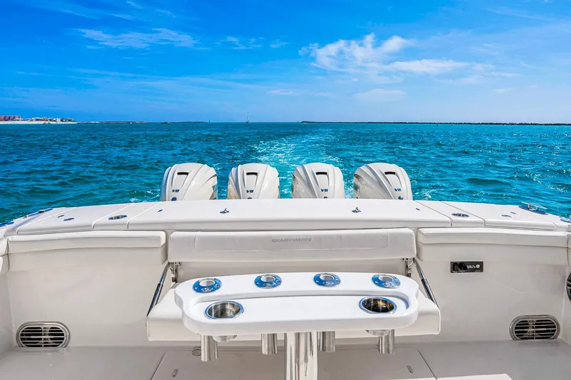  Yacht Photos Pics 2025 Grady-White Canyon 456 boat with four engines cruising on blue ocean waters.
