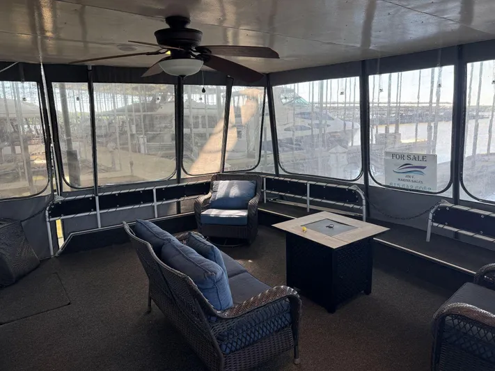  Yacht Photos Pics Enclosed deck of 1986 Stardust Cruisers 18 X 80 houseboat with seating and ceiling fan.