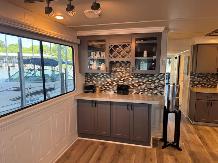  Yacht Photos Pics 1986 Stardust Cruisers houseboat interior with modern bar area, wood flooring, and large window view.