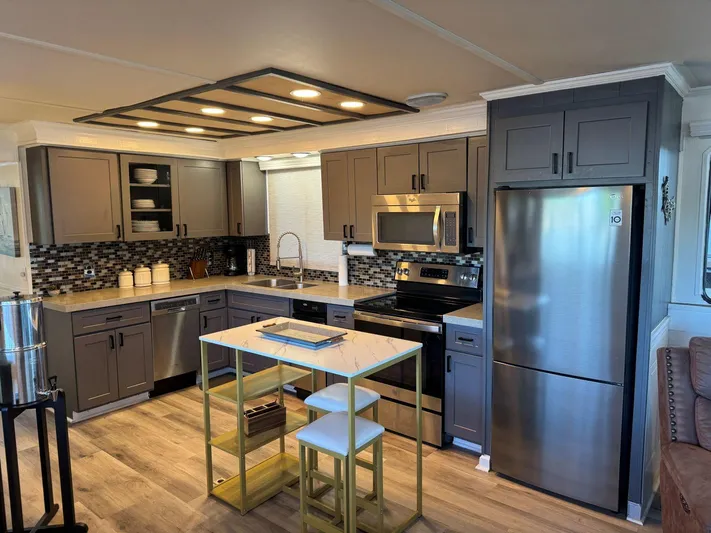  Yacht Photos Pics Modern kitchen interior on 1986 Stardust Cruisers 18 X 80 houseboat with stainless steel appliances.