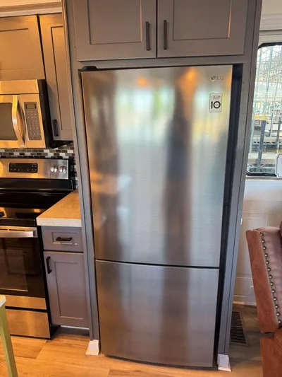  Yacht Photos Pics Stainless steel refrigerator in a 1986 Stardust Cruisers 18 X 80 houseboat kitchen.