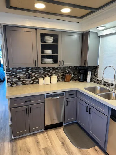  Yacht Photos Pics Modern kitchen in 1986 Stardust Cruisers 18 X 80 houseboat with gray cabinets and mosaic backsplash.