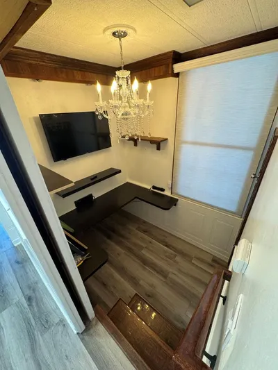  Yacht Photos Pics 1986 Stardust Cruisers houseboat interior with chandelier, TV, and modern decor.