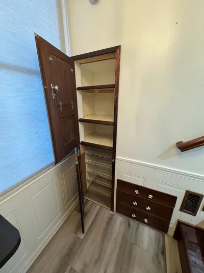  Yacht Photos Pics 1986 Stardust Cruisers houseboat interior with open wooden cabinet and drawers.