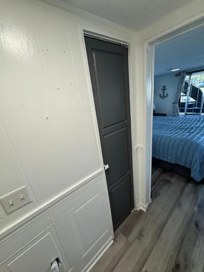  Yacht Photos Pics 1986 Stardust Cruisers houseboat interior with bedroom, wood flooring, and nautical decor.