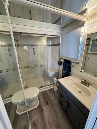  Yacht Photos Pics Bathroom in 1986 Stardust Cruisers 18 X 80 Houseboat with modern fixtures and glass shower.