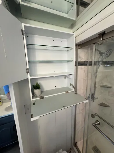  Yacht Photos Pics Open bathroom cabinet with glass shelves in a 1986 Stardust Cruisers houseboat.