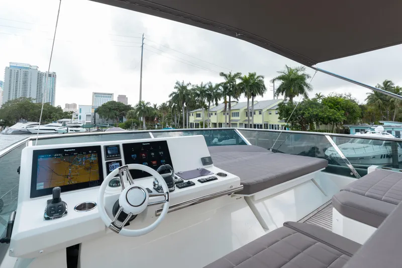 Knightlife Yacht Photos Pics Flybridge of 2017 Prestige 630 yacht with modern navigation system and cityscape background.