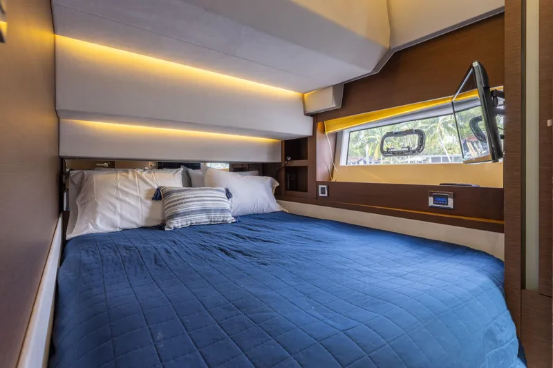 Knightlife Yacht Photos Pics Luxurious cabin interior of a 2017 Prestige 630 yacht with a cozy bed and window view.