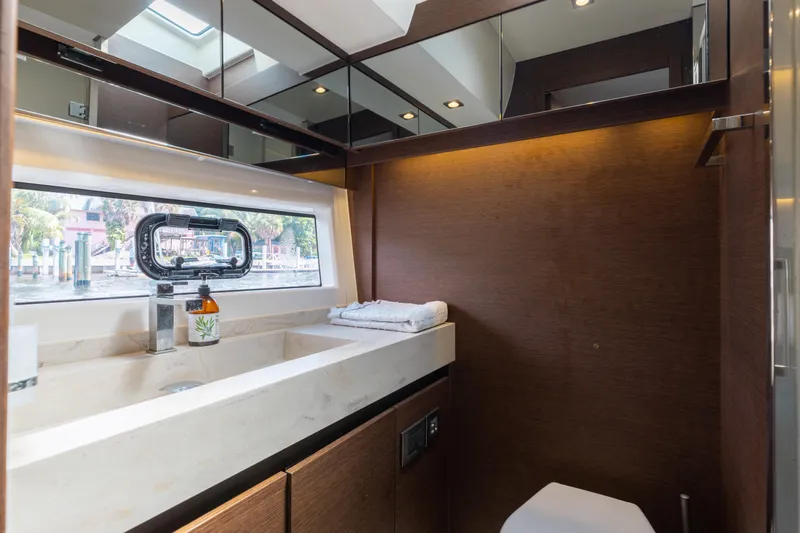 Knightlife Yacht Photos Pics Luxurious bathroom interior of 2017 Prestige 630 yacht with modern fixtures and window view.