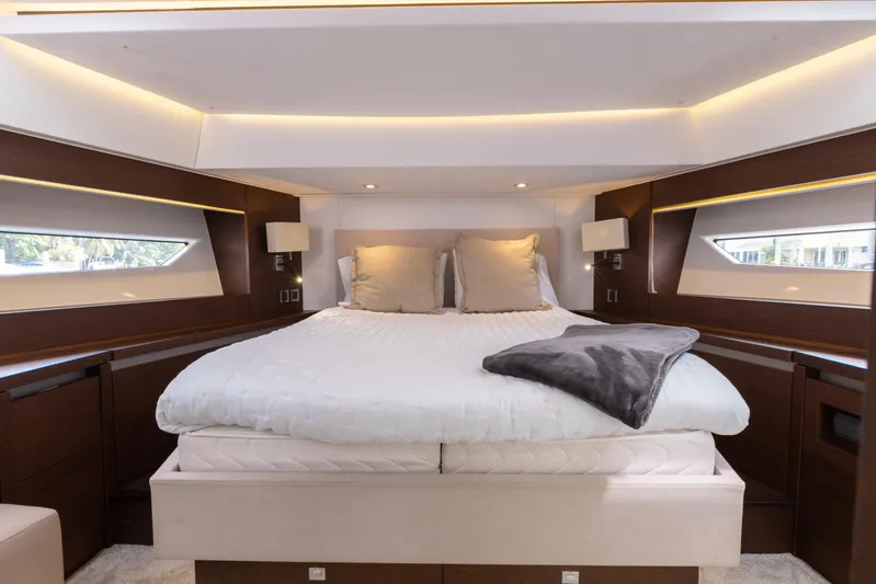 Knightlife Yacht Photos Pics Luxurious bedroom interior of 2017 Prestige 630 yacht with modern lighting and elegant bedding.