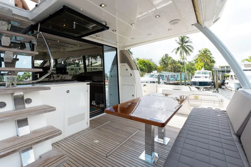 Knightlife Yacht Photos Pics Luxurious 2017 Prestige 630 yacht deck with seating, table, and marina view.