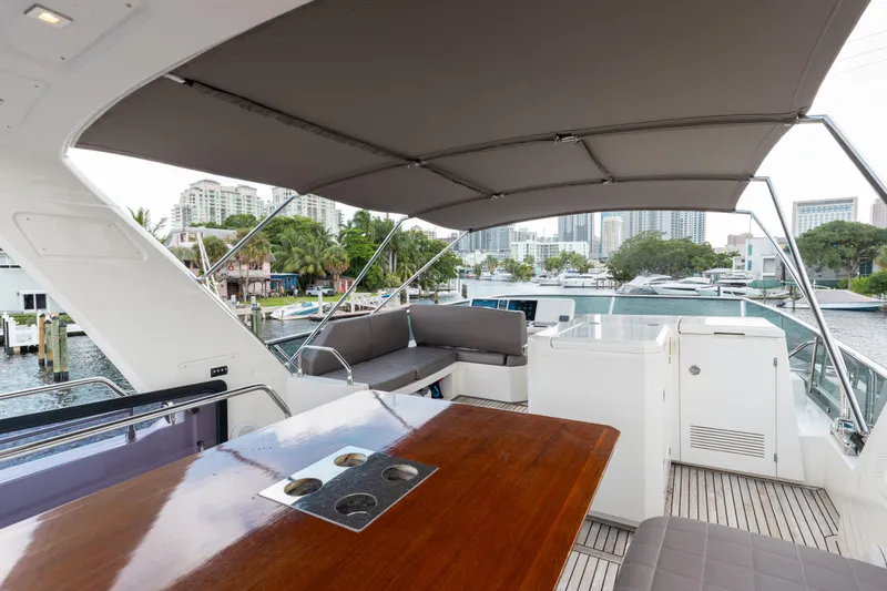 Knightlife Yacht Photos Pics Luxurious 2017 Prestige 630 yacht deck with seating and cityscape view.