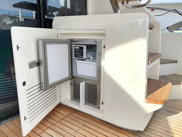  Yacht Photos Pics Open mini fridge on 2018 Ferretti Yachts 550, wooden deck and stairs visible.