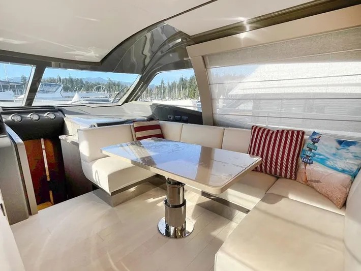  Yacht Photos Pics Luxurious interior of 2018 Ferretti Yachts 550 with elegant seating and table.