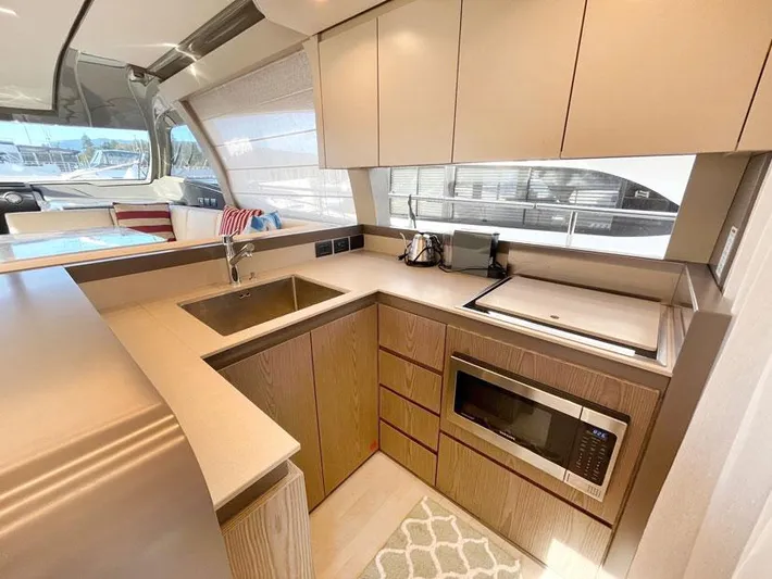  Yacht Photos Pics Modern kitchen interior on 2018 Ferretti Yachts 550, featuring sleek cabinetry and appliances.